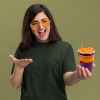 Portable snack and drink container, featuring a cup and snack compartment in one.