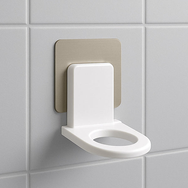 adhesive hook holding body wash and shampoo bottles view 2